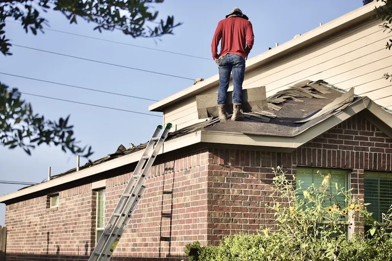 Professional roofer working on a residential roof in Anglevillas